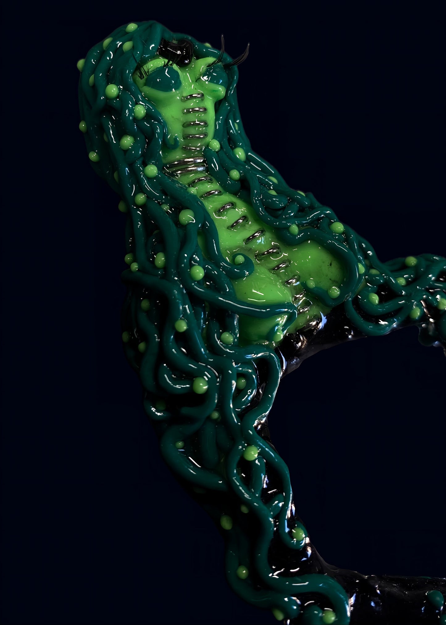 side profile close-up of alien torso and tentacles wrapping around mirror frame, high shine resin finish visible